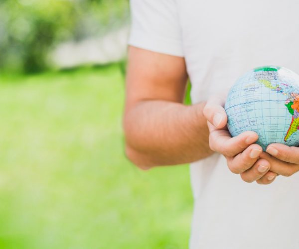 mid-section-man-holding-globe-hand