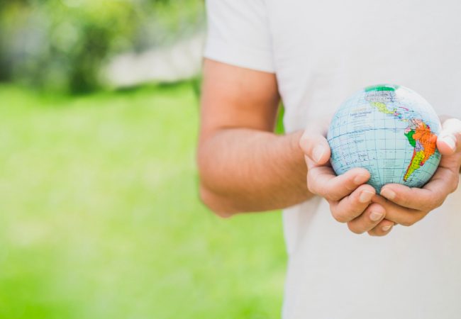 mid-section-man-holding-globe-hand